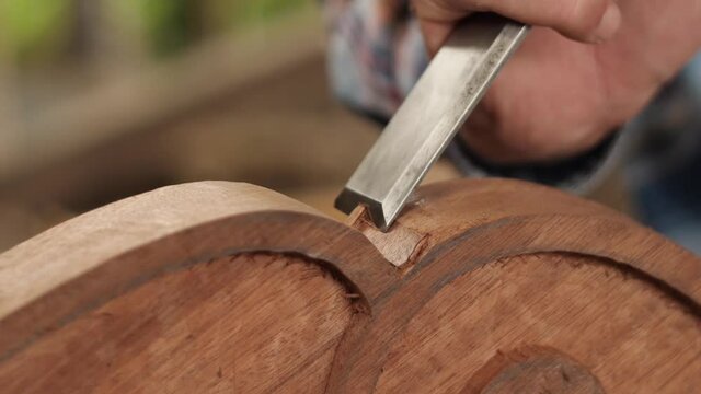woodcarver with a chisel cuts a tea tray. amazing asmr
