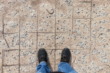 man standing on old crumbling concrete slab with rusty rebar