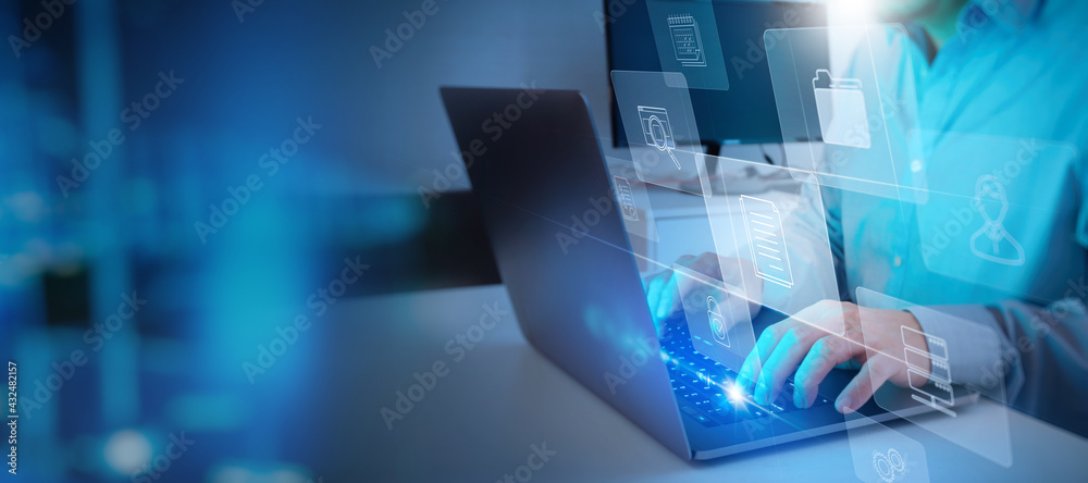 Poster ERP, document management concept.Businessman working with laptop computer with icons on virtual screen and office blur background.