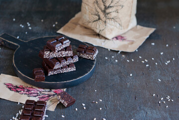homemade dark chocolate with puffed amaranth on the dark background