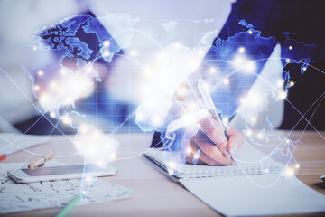 Double exposure of business theme drawing over people taking notes background. Concept of financial world