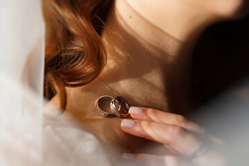 wedding rings on the bride's collarbone. traditional wedding decorations