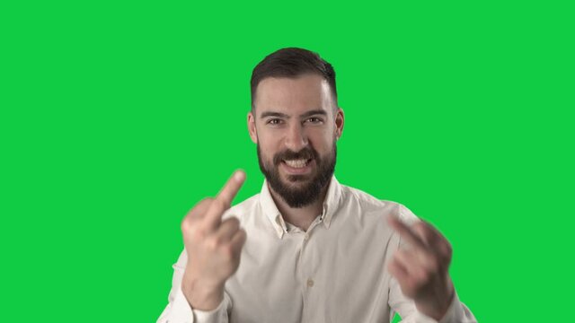 Rude angry business man showing middle finger obscene gesture at camera. Portrait isolated on green screen background. 