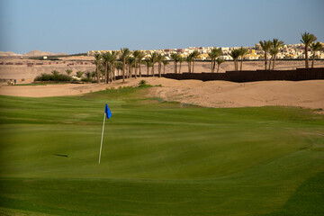 Golf field in the middle of palm trees and beautiful seashore at far east resort