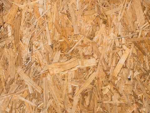 Oriented strand board-looks like a compressed scattering of chips and large shavings.