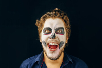 Masked man of the day of death on Halloween, laughing, disheveled hair