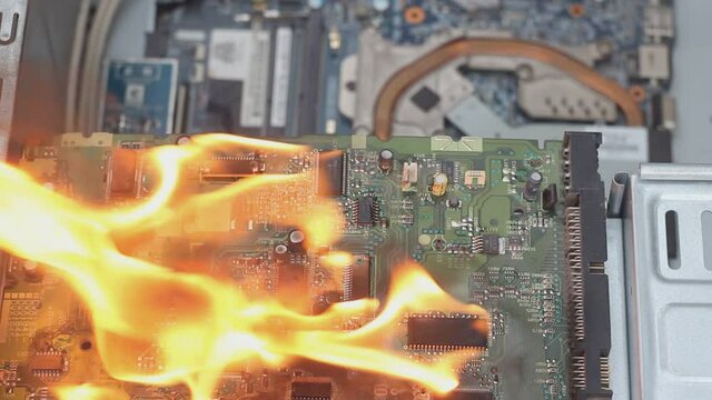 Fire of the computer and computer board in the apartment, faulty wiring, short circuit in the battery of the power supply. Concept: the cause of a house fire,