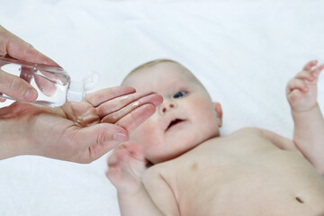 Apply antiseptic to your palms. Defocused child. Copy space - concept of hygiene, cleanliness, disinfection, antiseptic, prevention, virus, bacteria, microbes, immunity, disease infection, skin care