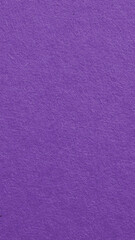 The surface of violet cardboard. Paper texture with cellulose fibers. Dark natural mobile phone wallpaper. Bright purple vertical background. Saturated color. Top-down. Macro