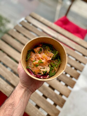 Take Away Salmon Salad Clean Eating Diet Concept. Vegeterian Seafood bowl with smoked Salmon Gravlax in Plastic Take Out Bowl.