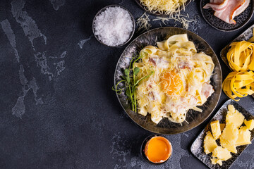 Carbonara pasta with egg sauce, bacon and grated parmesan cheese. Classic homemade pasta carbonara.