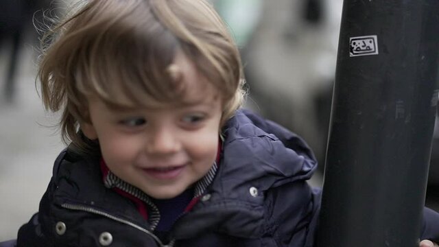 Child Boy Turning Around Metal Post Daydreaming, Kid Playing By Himself