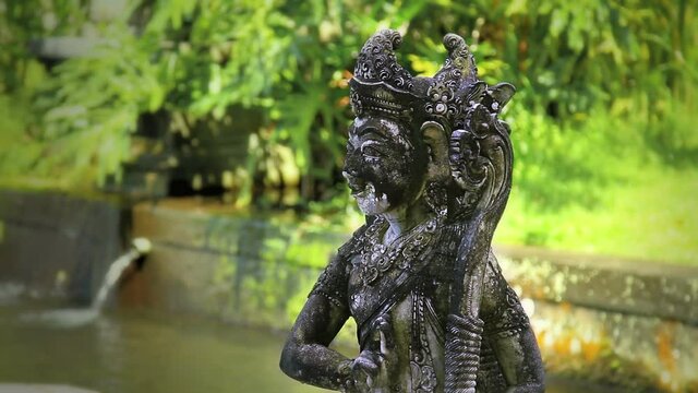 Balinese stone sculpture and glare of sunlight on it