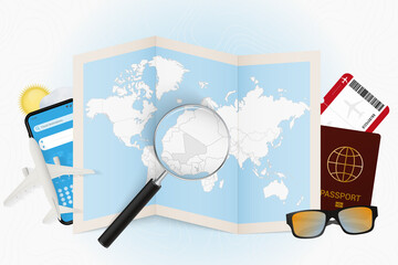 Travel destination Mali, tourism mockup with travel equipment and world map with magnifying glass on a Mali.