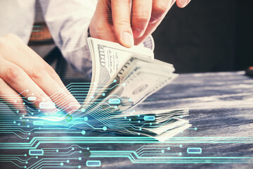 Double exposure of technology drawing hologram and us dollars bills and man hands. Data concept