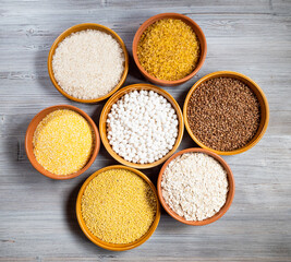 top view of raw groats in round ceramic bowls