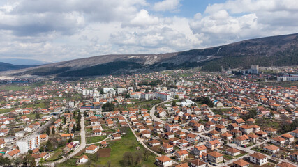 Aerial drone view Bileca, Bosnia and Herzegovina. Buildings, streets and residential houses. A view from above on the roof of the houses in city.  