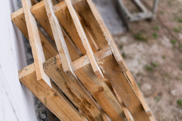 Construction wooden pallets are stacked in a pile