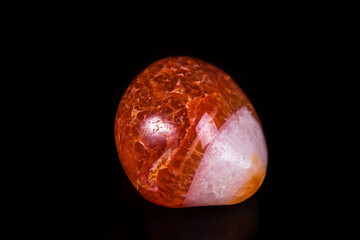 Macro mineral stone orange onyx on black background