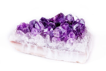 Macro mineral stone purple amethyst in crystals on a white background