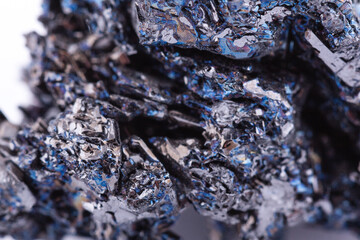 Macro mineral stone covellite on white background