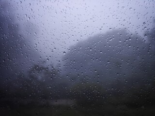 Condensation on the clear glass window. Water drops. Rain. Abstract background texture, india.