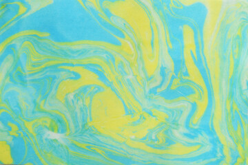 Abstract art by blue and yellow watercolor on a paper