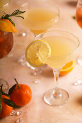 Yellow christmas alcoholic lemonade with oranges, tangerines and rosemary in many glasses
