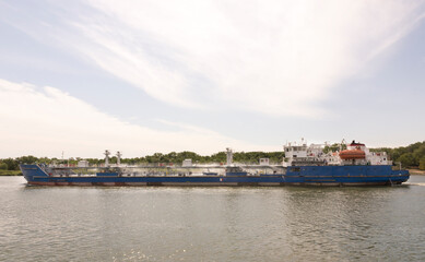 Fototapeta na wymiar Tanker follows along the banks of the River Don