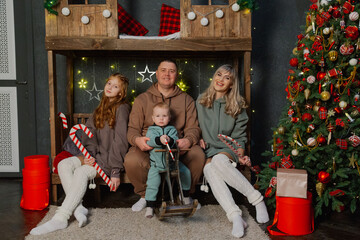 Happy family on new year's bed in a photo studio.