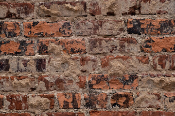 Very old brick wall close up showing decay and weathering