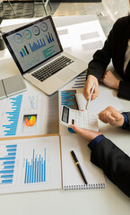 Businessman, accounting, calculating, analyzing, charting and graphing income with a modern laptop...