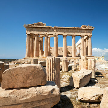 Parthenon temple on a bright day with blue sky. Panoramic image taken in Acropolis hill in Athens, Greece. Classical ancient Greek civilization landmark, famous place, panoramic travel background.