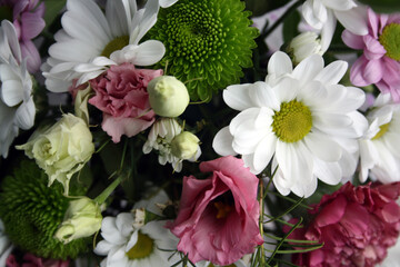 Bouquet of white chrysanthemums, pink lisianthus and carnations.