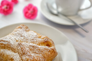 Close up of puff pastry with curd filling on a coffee table