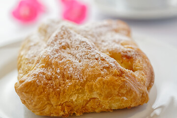 Close up of puff pastry with curd filling on a coffee table