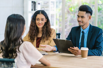 Senior Asian Manager explaining or answering about job description and benefits to Young Asian...