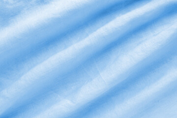 Beautiful texture of blue linen fabric wavy folds