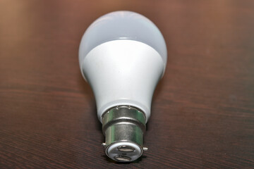 Energy-saving light bulb on brown background