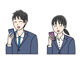 Fototapeta premium 笑顔でスマホを見るスーツ姿の若い男女