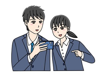 一緒にスマホを見るスーツ姿の若い男女