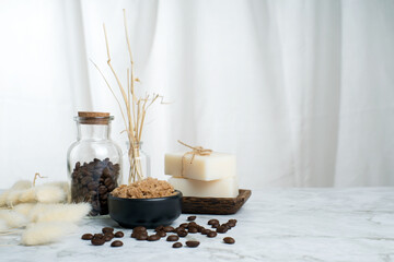 Coffee bath salt spa and soap with coffee seed in glass bottle on white grey marble table.