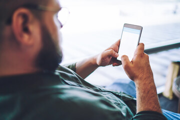 Man using smartphone having free time