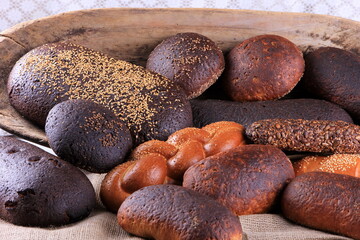 Still life with different types of bread: black, rye, white bread, bread with seeds. bread and wheat ears. 