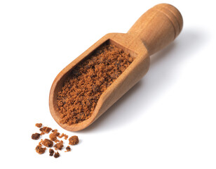 brown granulated sugar in the wooden scoop, isolated on pure white background