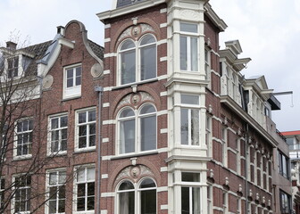 Fototapeta na wymiar Amsterdam Traditional Brown Brick House Facades