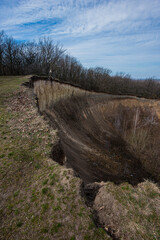Fototapeta premium Erosion of the hillside and pollution of the surrounding nature by human activities.