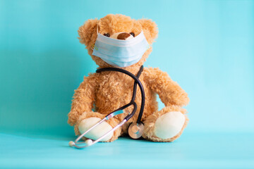 Teddy bear doctor with a stethoscope on white background