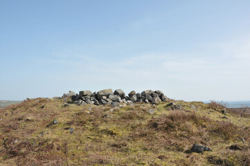 the exposed stones at the top of a cairn known as the millers grave on midgley moor in calderdale...
