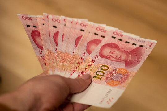 Chinese Yuan renminbi banknotes, paper money, Bank of China currency. Chinese financial system. Income and payments concept.